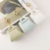 Nuevo Monedero Creativo Color Caramelo Llavero de Auriculares Moda Femenina Bolso de Almacenamiento de Cuero Versátil Colgante Regalo