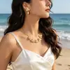 Colar feminino versátil e elegante com pingente de estrela-do-mar, concha e vieira em liga metálica, estilo oceano e com design transfronteiriço.