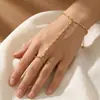 Cadena de dedos de moda transfronteriza estilo INS, pulsera de cadena de anillo de circonita chapada en oro real de cobre, joyería personalizada de moda al por mayor para mujeres