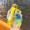 Llavero creativo de concha pequeña con aceite, lindo colgante pequeño de arena movediza líquida, accesorios para bolso, pequeño colgante de regalo, venta al por mayor