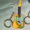 Nuevo llavero de acrílico para guitarra, instrumento compacto de alto valor, simple, 2D, transfronterizo, colgante para mochila para chicas modernas