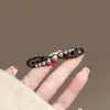 Horquilla de perla elegante para mujer, con lazo negro, de metal, con clip lateral avanzado, para flequillo, con clip de pico de pato simple