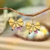 Pendientes acrílicos versátiles y elegantes estilo universitario con lazo para mujer, pendientes de lápiz de nicho para temporada de graduación, lindos y modernos
