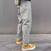 Pantalones casuales holgados cónicos funcionales de tres capas tipo softshell estilo americano con etiqueta blanca para hombres y mujeres, pantalones largos para hombres