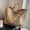 Bolso de gran capacidad para mujer primavera/verano versátil 2023 nuevo bolso bandolera de lona texturizada portátil para ir al trabajo Bolso tote tipo cubo