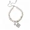 Pulsera de cordón ajustable con flor de circón y perla de estilo francés, una pieza de joyería lujosa y elegante que es tanto dulce como versátil