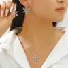 Pendientes de Copo de Nieve de Invierno Incrustados de Diamantes Transfronterizos Europeos y Americanos Lujo Accesible Moda de Alta Gama Pendientes de Moda Creativos con Perlas Pendientes para Mujer