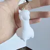 Llavero de oso con líquido diy llavero de conejo con líquido blanco al por mayor oso cabeza grande oso bloque de construcción hombre espacial pequeño leche Dragón