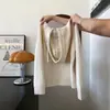 Suéter de tricô com capuz e mangas compridas, na cor damasco, com modelagem solta, adequado para usar em camadas ou sozinho, feminino, outono 2026, top estiloso para baixinhas
