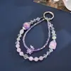 Nuevo colgante de teléfono de doble cadena con un toque de alta gama, cuentas luminosas de flor de cerezo, correa de muñeca para teléfono, charm para bolso, pequeño regalo para mujeres