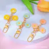 Estilo Ins Flor de Margarita con Goteo de Aceite Borla Llavero Creativo Colgante para Bolsa de Auriculares de Niñas Venta Caliente