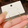 Pendientes metálicos simples, elegantes y compactos con un diseño único, pendientes de estrella de circón, nuevos pendientes de moda de celebridad de Internet 2026