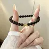Joyería de piedra estilo neutro: cuentas de obsidiana natural combinadas con cuentas espaciadoras de cuarzo rutilado dorado. Las parejas pueden usar esto como una pulsera de una sola hebra