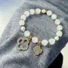 2025 Nova Pulseira de Vidro Olho de Gato Imitado Trevo de Quatro Folhas Cordão Elástico Nicho Pulseira de Pérolas