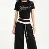 25 años primavera y verano nuevo diseño de encaje de color contrastante cintura elástica caída deportes casuales ligeramente holgados de campana pantalones para mujer