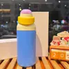 Nueva botella de agua térmica estilo macarrón de comercio exterior, hecha de acero inoxidable 304, con tapa abatible portátil, adecuada para hombres, mujeres y estudiantes; una botella de agua linda