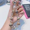Cadena para teléfono móvil con cuentas pintadas a mano, colgante de muñeca con cuentas de cristal, hecha a mano, linda, nueva cadena, venta al por mayor, cadena colgante para funda de teléfono móvil, cordón