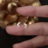 Pendientes de plata de ley S999 con forma de estrella hueca, nuevos y elegantes, de estilo coreano, con circonitas y plata pura.