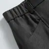 Pantalones casuales plisados de estilo americano para calle, fluidos, con diseños de moda, bolsillos únicos, color liso y corte holgado de pierna ancha para hombre.