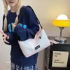 Bolsas Pequenas para Homens e Mulheres 2025 Primavera Nova Moda Estilo Coreano Bolsa de Ombro Único Transversal Bolsa Quadrada Pequena de Lona com Bloqueio de Cor Estudante Tendência