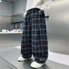 Pantalones casuales de cuadros para niño otoño 2026 nuevo estilo para niños mayores primavera y otoño holgados rectos largos de moda venta al por mayor