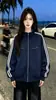 Chamarra con cierre de manga larga, diseño personalizado de moda de nicho, bloques de color de tres franjas para mujer, nuevo top casual de otoño e invierno