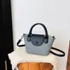 Bolsa de mão pequena vintage de nicho transfronteiriça de alta qualidade para mulheres, nova bolsa de ombro versátil 2026, bolsa transversal fosca