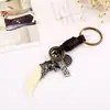 Directo de fábrica retro tejido resina piel de diente de perro llavero hebilla de bolsa DIY anillo de llave de cuero punk para hombre