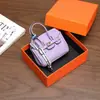 Nuevo y moderno colgante de mini bolso de platino, bolso de lipstick de alta gama, decoración de bolso para auriculares, accesorio de llavero para coche, venta al por mayor