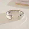 Pulsera Abierta Metálica Brillante con Forma de Cruz y Gota de Agua Transfronteriza Europea y Americana, Pulsera de Diseño de Moda Vintage, Joyería de Mano de Gama Alta de Nicho