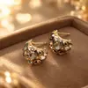 Moda Temperamento Venta Caliente Ojo de Tigre Estilo de Corte Francés Exquisitos Pendientes de Botón para Mujer Sentido del Diseño Nicho Fuente Directa de Fábrica