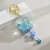 Llaveros creativos de dibujos animados con carillones de viento de aceite, adornos para pareja, colgantes para coche y bolsa, accesorios para llaves, regalo pequeño al por mayor