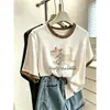 Camiseta de algodón de manga corta para mujer, con bloques de color, hombros normales y diseño de copo de nieve, de nicho y elegante, adecuada para ir al trabajo, adelgazante y versátil, un artículo popular para el verano de 2026