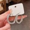Pendientes circulares de lujo y luz de alta gama, de metal, súper llamativos, con un diseño de nicho, estilo europeo y americano, estilo frío para mujer.