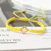 Pulsera tejida de nudo plano de trébol de cuatro hojas de venta caliente transfronteriza para parejas y estudiantes, tendencia europea y americana inspirada en la dopamina, joyería al por mayor de fabricante