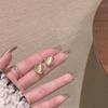 Novos brincos de pedra de olho de gato geométricos torcidos com zircônia, brincos femininos artísticos leves e luxuosos com design de nicho