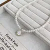 26 novos modelos de colares de pérolas para saias de madrepérola branca, correntes de clavícula simples e elegantes, pingentes de pérola de design nicho de luxo leve para mulheres