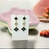 Exquisitos Pendientes de Trébol de Cuatro Hojas Negros y Blancos con Microincrustaciones y Borlas, Pendientes Simples Dulces y a la Moda, Pendientes de Lujo Ligero y de Alta Gama al por Mayor