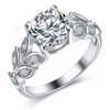 Anel de noivado popular de folha transfronteiriço anel de zircônia com quatro garras Anel de metal com diamante de flor moderno personalizado feminino