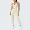 Conjunto de outfit de yoga ajustado con diseño deportivo en la espalda, de tela cepillada con bloques de color transfronterizos, sensación nude, pantalones largos de cintura alta para levantar glúteos para correr y fitness