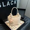 Bolso de Mano Estilo Coreano para Viaje al Trabajo para Mujeres 2026 Nuevo Modelo de Verano de Gama Alta de Nicho Bolso Cubo Versátil de Hombro