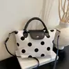 Bolsa de poá com design de nicho transfronteiriço para mulheres, novo modelo 2026, bolsa de mão artística, bolsa pequena quadrada transversal casual versátil