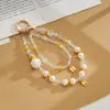 Nuevo colgante de teléfono de doble cadena con un toque de alta gama, cuentas luminosas de flor de cerezo, correa de muñeca para teléfono, charm para bolso, pequeño regalo para mujeres