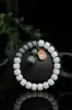 Material de intemperie de raíz de Bodhi de Jade Blanco de Hainan hecho a mano pulido en seco alto lanzamiento espaciador de cuerda trenzada colgante de loto tallado pulsera pulsera