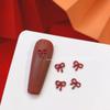 Joyería de uñas con lazo rojo de Año Nuevo en línea para celebridades, nueva serie de aleación de perla de diamante, diamantes decorativos para uñas al por mayor