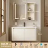 Tocador de baño engrosado y ahorrador de espacio con diseño en color crema, que cuenta con un lavabo redondeado, lavabo cerámico integrado y un lavabo de una sola pieza.