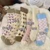 Meias térmicas grossas para outono e inverno, projetadas para reter o calor, com textura de felpa em laço, meias femininas de cano médio, casuais e versáteis, com design color-block