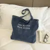 Bolsa de lona de mezclilla lavada con textura en tono azul vintage para estudiantes universitarias, casual y versátil para viajes y compras, bolso de hombro