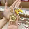 Versión Dorada del Bolso Colgante para Teléfono Móvil Flor Rica Llavero de Oro Puro Llave Colgante de Oro Transmisión en Vivo