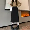 Falda de lana negra de longitud media en línea A con abertura trasera para mujer, nueva falda casual de cintura alta adelgazante Otoño 2026